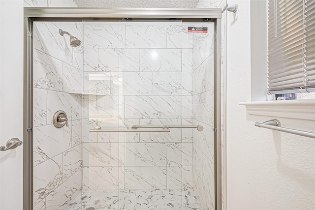 bathroom with a shower stall