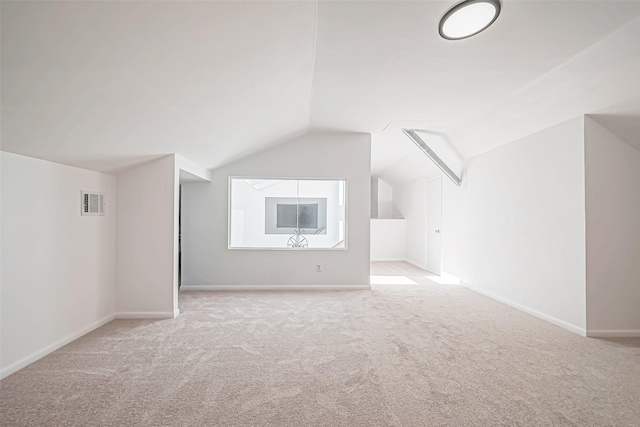bonus room with visible vents, baseboards, carpet, and vaulted ceiling