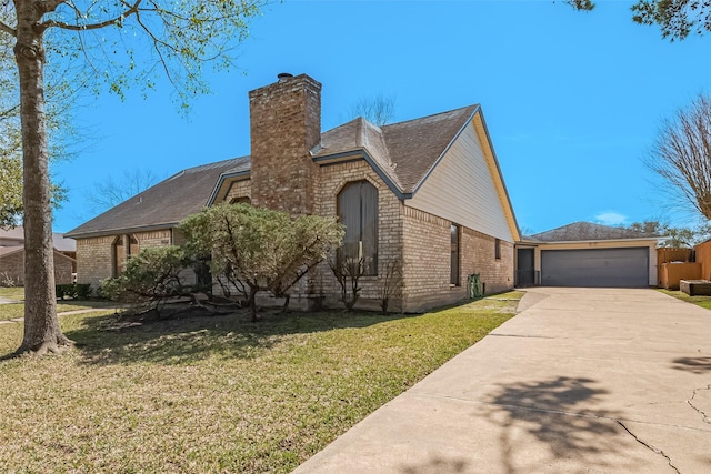 view of front of house with concrete driveway, a front yard, a garage, brick siding, and a chimney