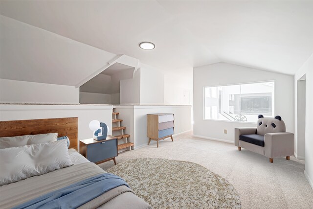 carpeted bedroom with baseboards and vaulted ceiling