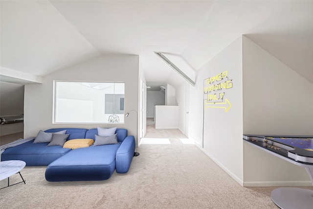 carpeted living room with vaulted ceiling and baseboards