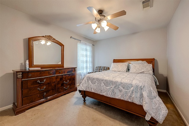 carpeted bedroom featuring baseboards, visible vents, and ceiling fan