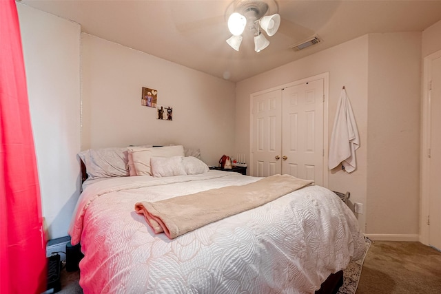 bedroom featuring a closet, visible vents, a ceiling fan, carpet flooring, and baseboards