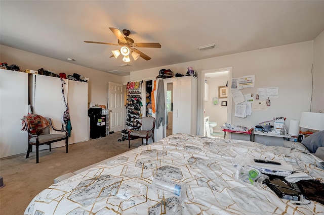 carpeted bedroom featuring ceiling fan, connected bathroom, and visible vents