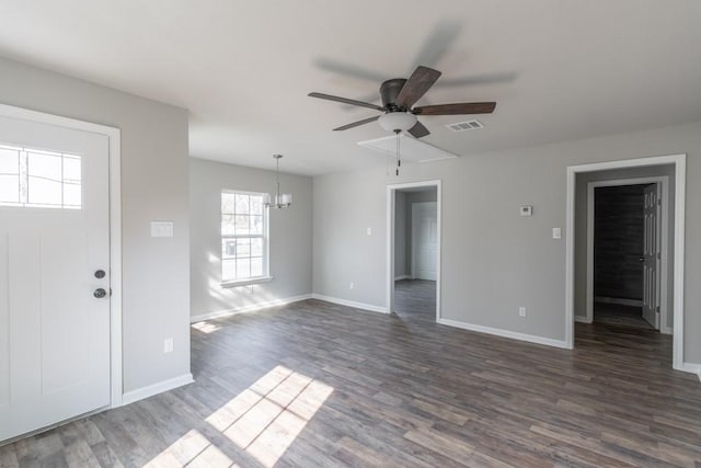 interior space featuring dark wood-style floors, ceiling fan, visible vents, and baseboards