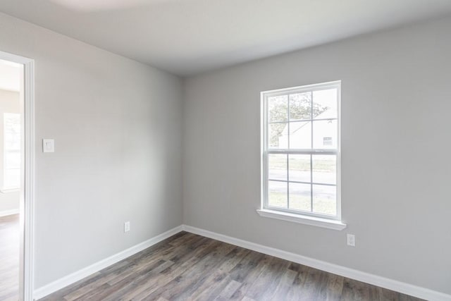 unfurnished room with wood finished floors and baseboards