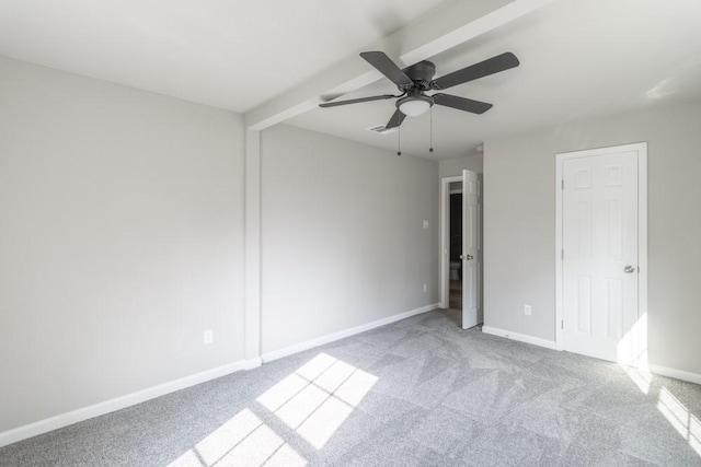 unfurnished bedroom with beam ceiling, carpet flooring, ceiling fan, and baseboards