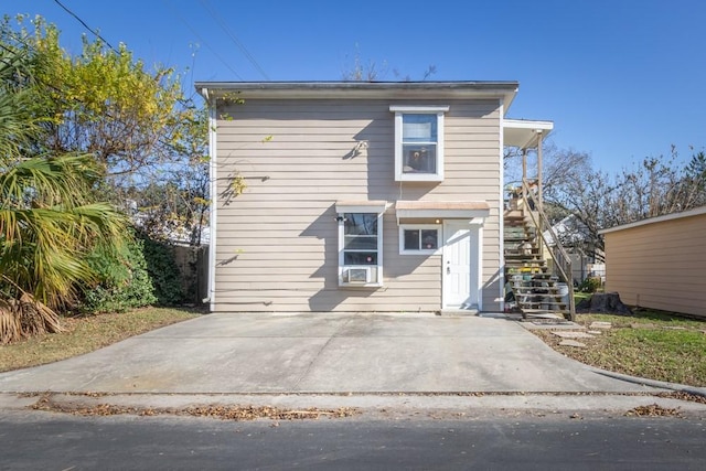 view of front of property featuring stairway