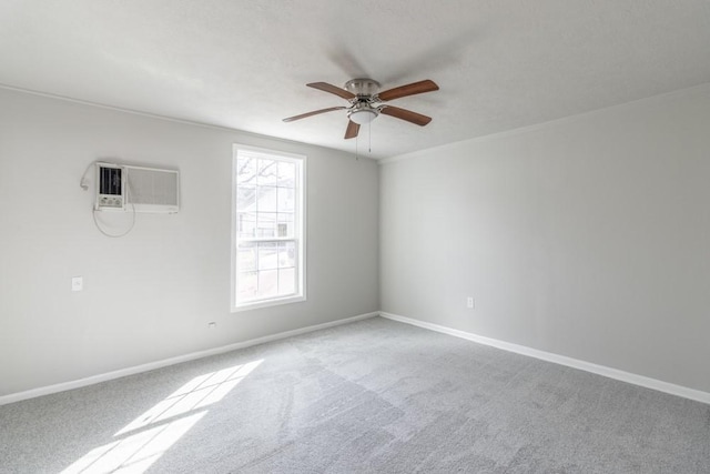 carpeted empty room with ceiling fan, baseboards, and a wall mounted AC