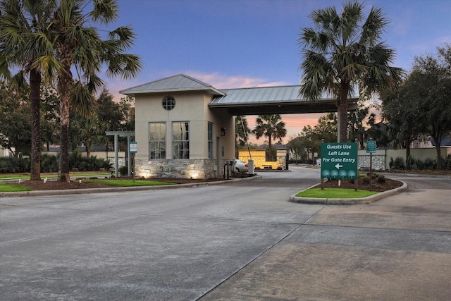 property at dusk featuring concrete driveway