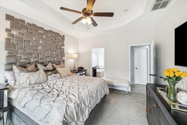 bedroom with ceiling fan, carpet, visible vents, and a raised ceiling