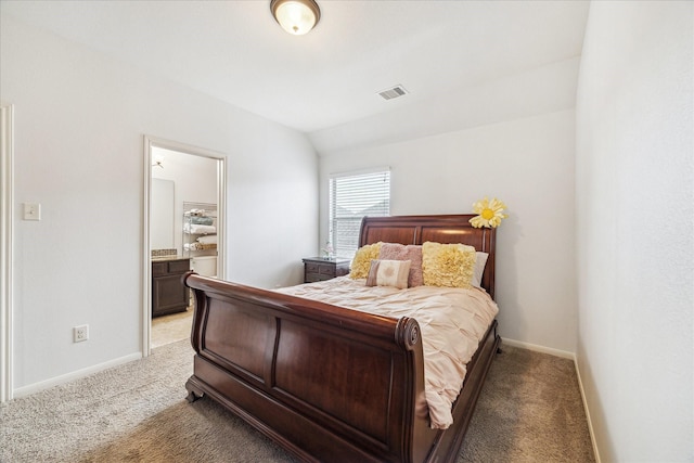 bedroom with baseboards, visible vents, connected bathroom, light colored carpet, and vaulted ceiling