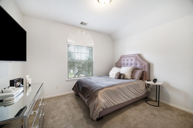 bedroom with lofted ceiling, baseboards, visible vents, and light colored carpet