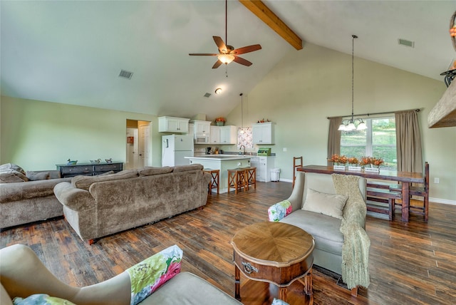 living room with beamed ceiling, dark wood-style flooring, and visible vents