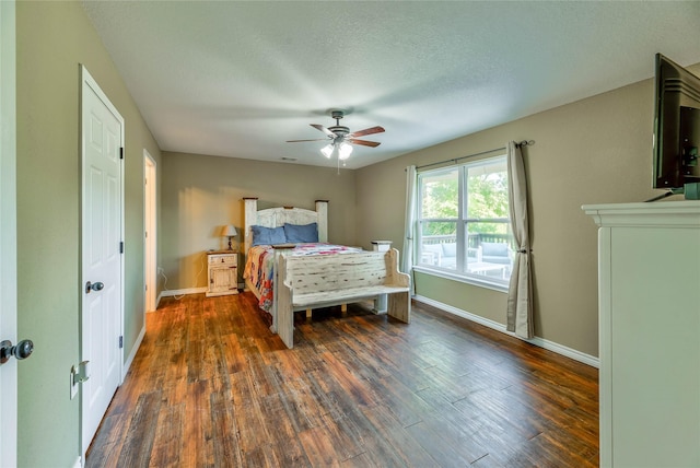 bedroom featuring visible vents, dark wood-type flooring, ceiling fan, a textured ceiling, and baseboards