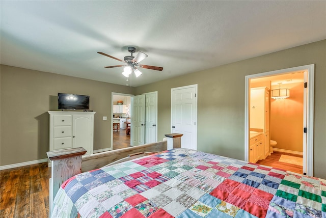 bedroom with ceiling fan, ensuite bath, wood finished floors, and baseboards