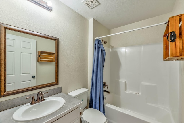 full bath with a textured ceiling, a textured wall, toilet, vanity, and visible vents