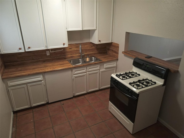 kitchen with butcher block counters, a sink, white cabinetry, tile patterned floors, and gas range