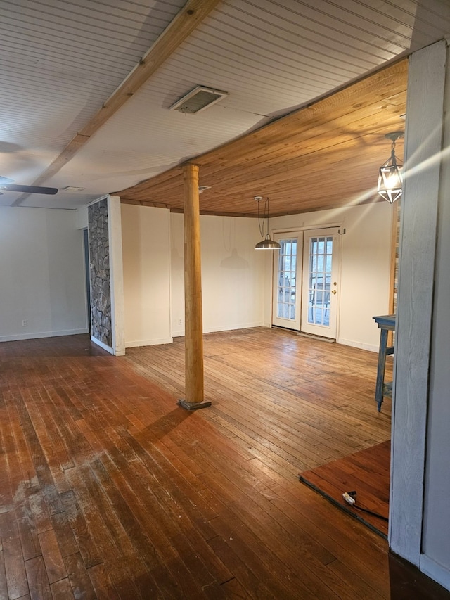 interior space featuring wooden ceiling, hardwood / wood-style flooring, baseboards, and visible vents