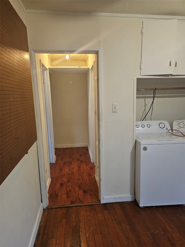 washroom featuring hardwood / wood-style flooring, baseboards, cabinet space, washer / clothes dryer, and attic access