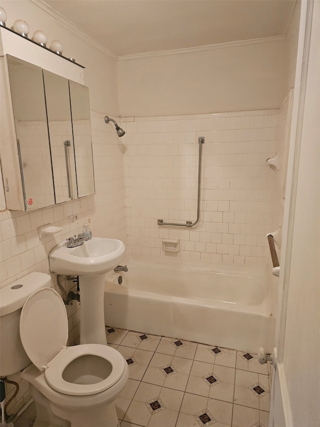 bathroom with crown molding, tile walls, shower / bathtub combination, toilet, and a sink