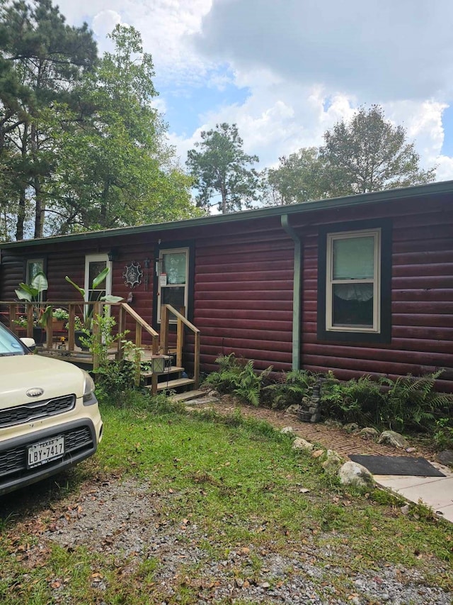 view of front of property featuring log veneer siding