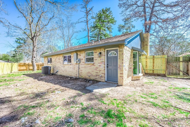 view of outdoor structure featuring a fenced backyard and central air condition unit