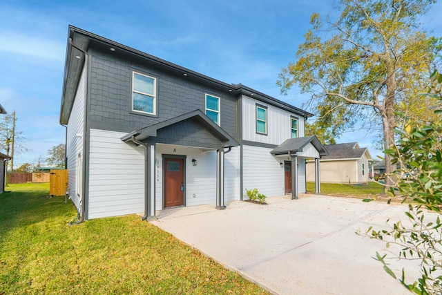 view of front of home with a front yard and fence