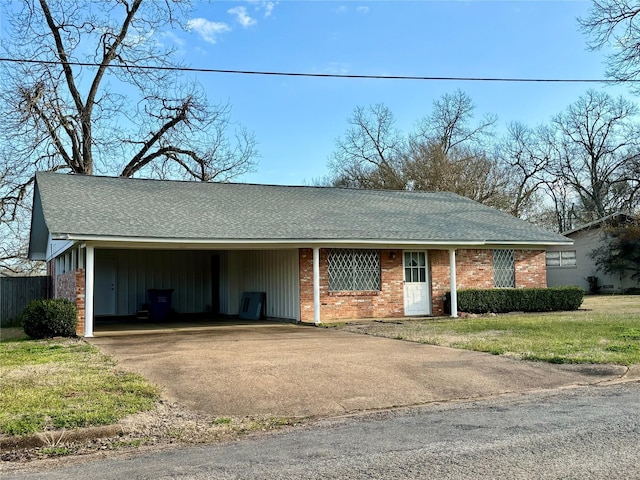 single story home with concrete driveway, brick siding, a front lawn, and a shingled roof