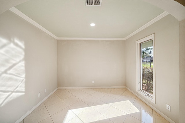 spare room featuring arched walkways, light tile patterned floors, visible vents, baseboards, and crown molding