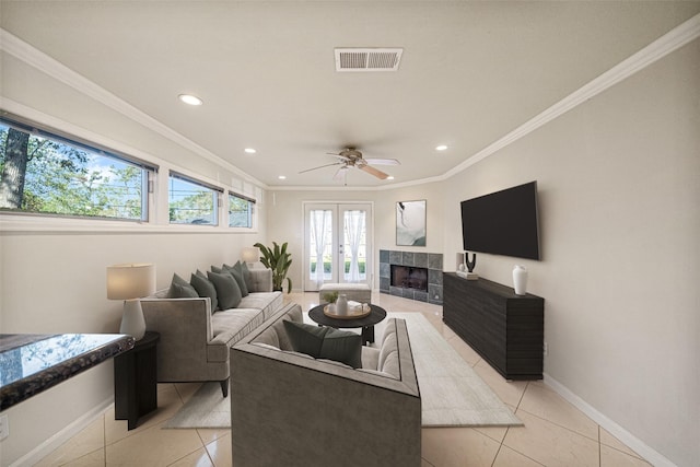 living area with french doors, light tile patterned flooring, visible vents, and crown molding