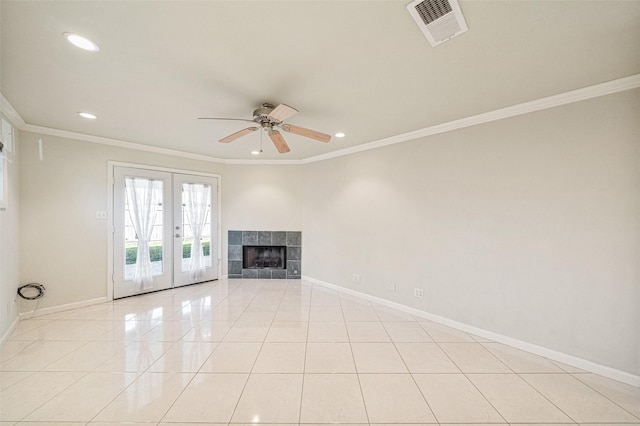 unfurnished living room with light tile patterned floors, baseboards, visible vents, ornamental molding, and a fireplace