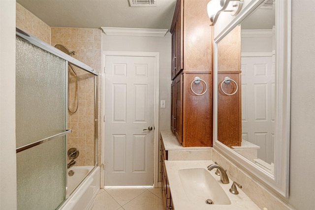 bathroom with tile patterned flooring, shower / bath combination with glass door, visible vents, vanity, and crown molding