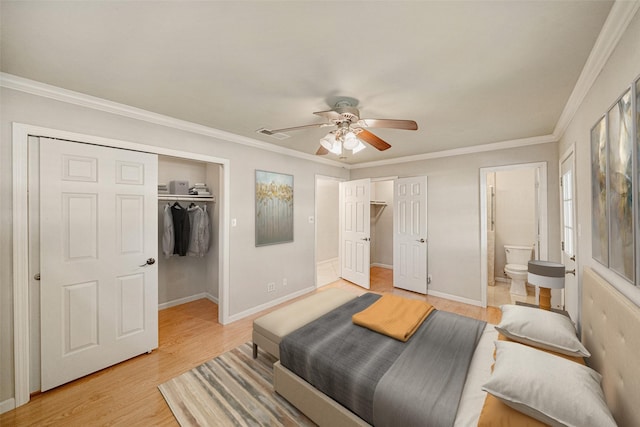 bedroom featuring light wood-style flooring, a closet, ornamental molding, and a spacious closet