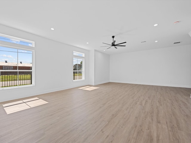 unfurnished room with light wood finished floors, recessed lighting, visible vents, ceiling fan, and baseboards