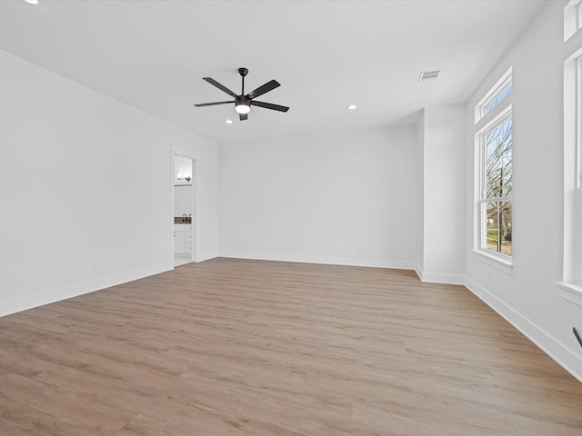 unfurnished room with light wood finished floors, recessed lighting, visible vents, and baseboards