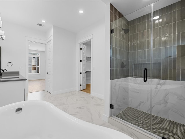 full bathroom with a stall shower, baseboards, visible vents, marble finish floor, and a freestanding tub