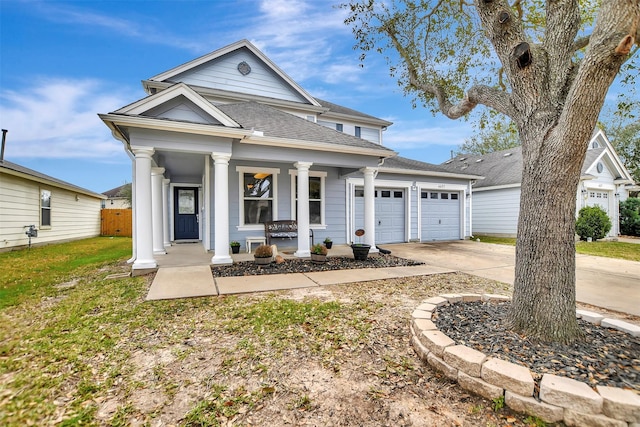 neoclassical / greek revival house with an attached garage, covered porch, concrete driveway, roof with shingles, and a front yard