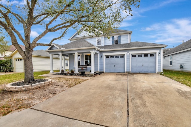 traditional-style home featuring a garage, concrete driveway, a porch, and a shingled roof