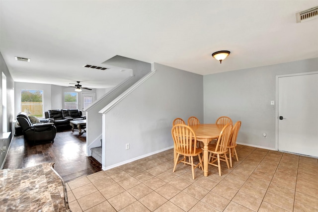 dining space with baseboards, stairs, and visible vents