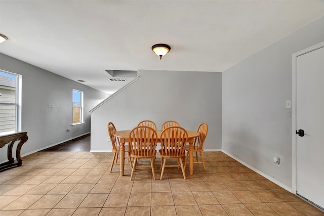 dining room with light tile patterned floors, visible vents, and baseboards