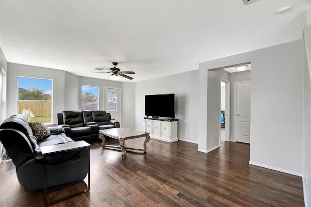 living room with ceiling fan, dark wood-style flooring, and baseboards