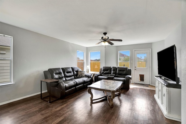 living area featuring dark wood-style floors, ceiling fan, and baseboards