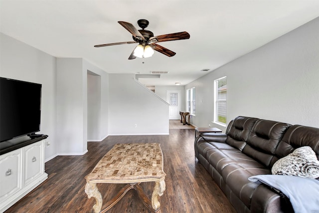 living area featuring visible vents, wood finished floors, a ceiling fan, and baseboards