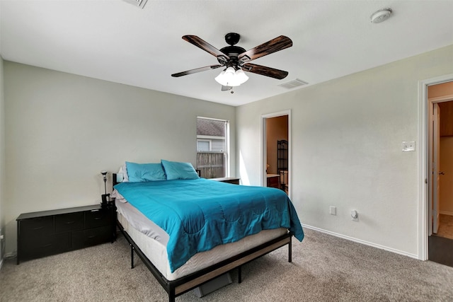 bedroom featuring baseboards, visible vents, a ceiling fan, ensuite bath, and carpet flooring