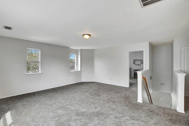 empty room with carpet floors and visible vents