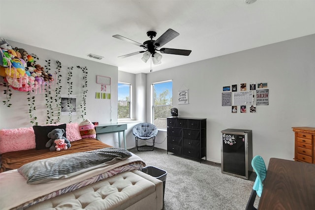 carpeted bedroom featuring visible vents and ceiling fan