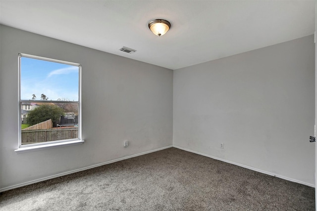 unfurnished room with baseboards, visible vents, and carpet flooring