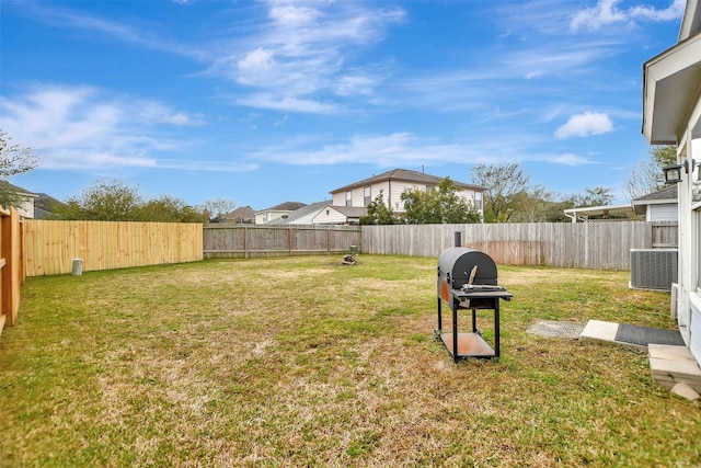 view of yard featuring a fenced backyard and central air condition unit