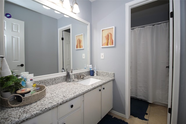 bathroom featuring tile patterned flooring and vanity